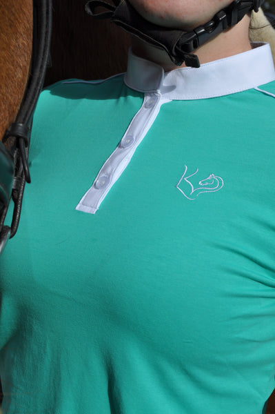 Close up of Green everyday riding shirt with lucky kids equine logo and white trim detail