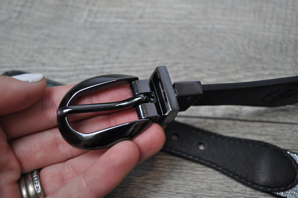 Close up of metal buckle on childrens reversible belt