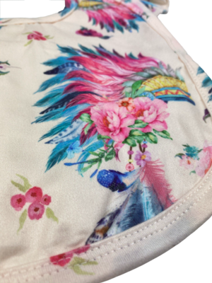 Close up of native headdress pattern frilled baby bib