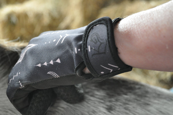 Close up of black bull horse riding gloves wrist fastening