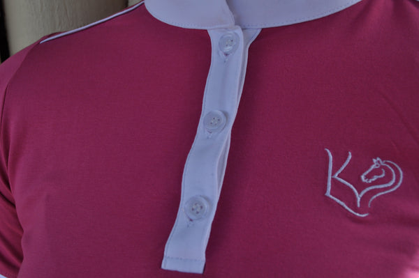 Close up of Pink everyday riding shirt with lucky kids equine logo and white trim detail