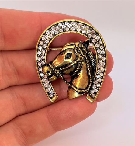 Gold alloy diamante horse and horse show brooch