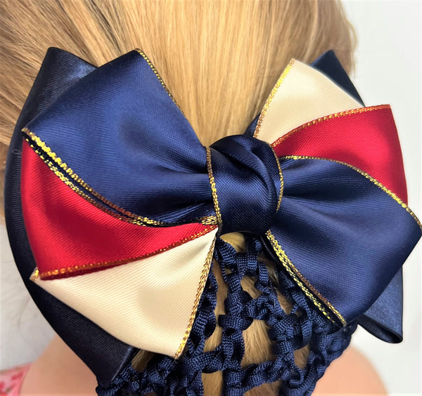 Clue up of navy blue hair net with red, navy blue and cream bow with gold edges