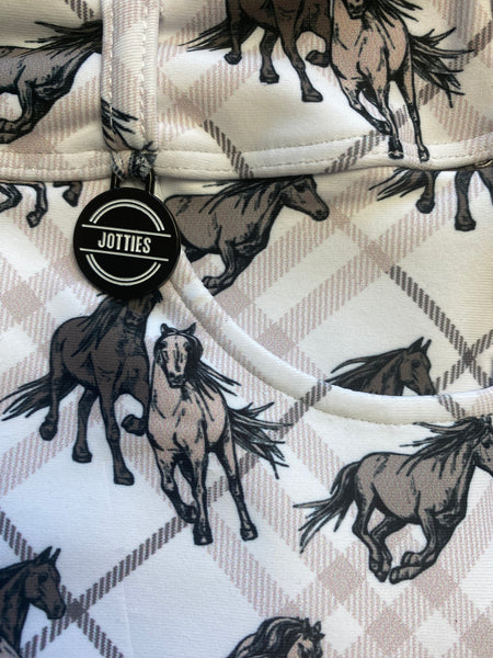 Close up of Jotties with checkered and wild horses pattern tag